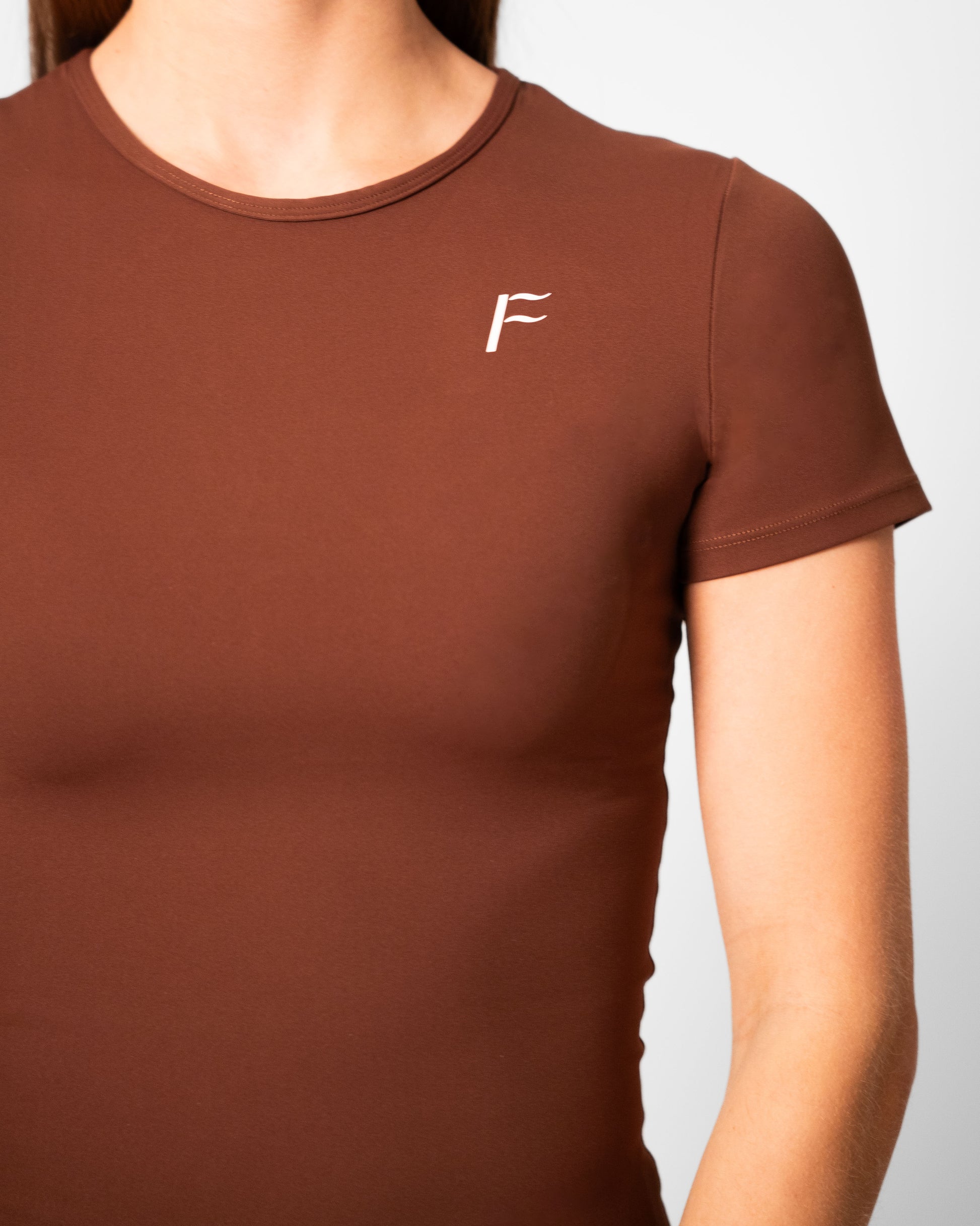 logo Fanatique donkerbruin sport shirt dames fitness shirt seamless stretch naadloos sport shirt t-shirt dames seamless sport shirt  Fanatique Sportswear